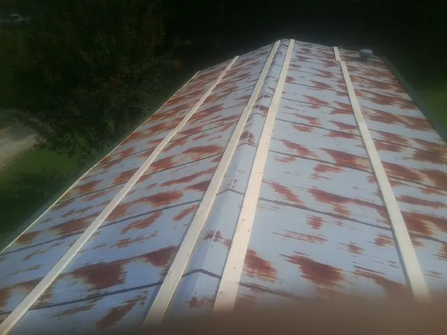 Rusted metal roof panels with new wood purlins before replacement — Storm Damage Roof Repair in Park Forest by Roofing Brothers