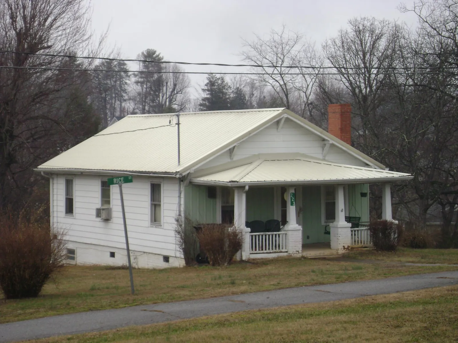 White metal roof on a craftsman bungalow at a street corner in Park Forest